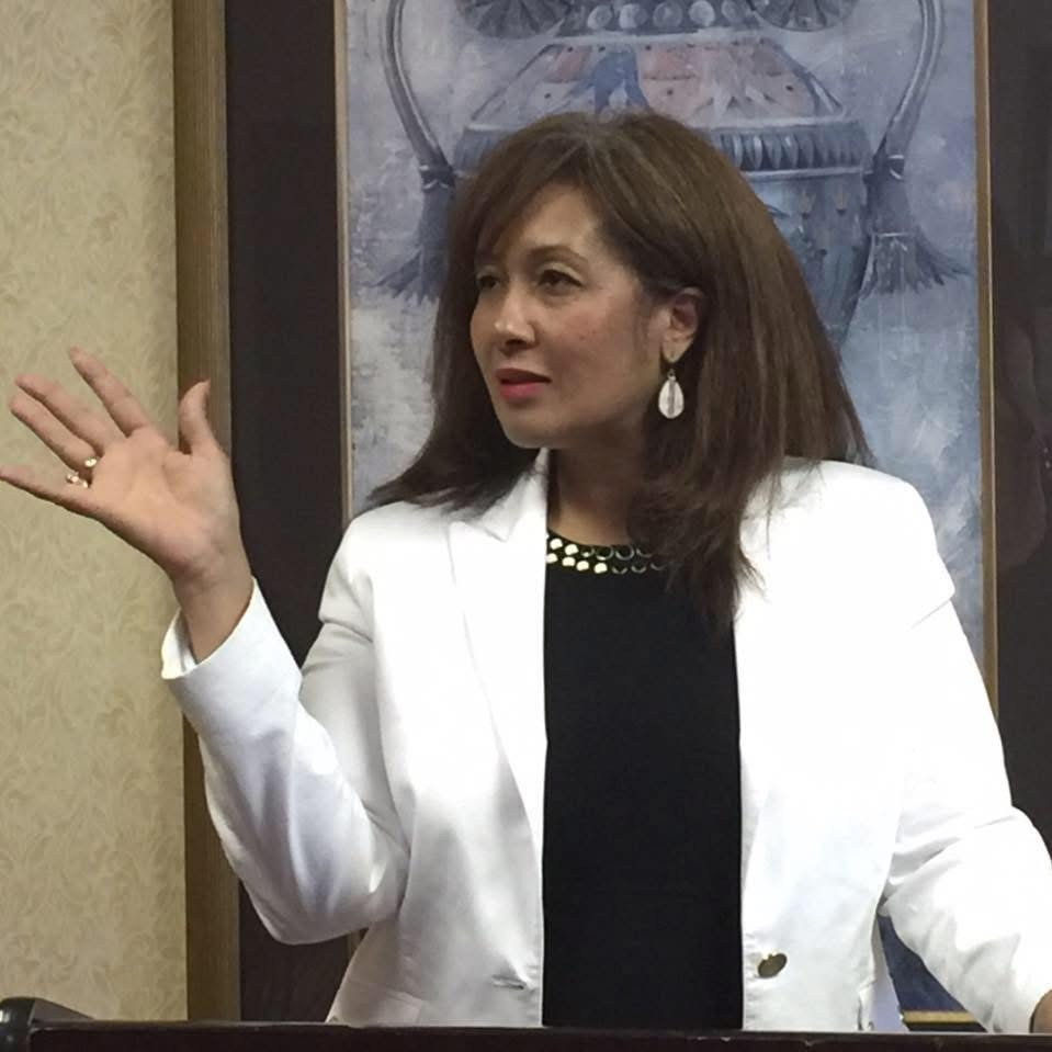 Founder of The Gift Ministries speaking at a podium.